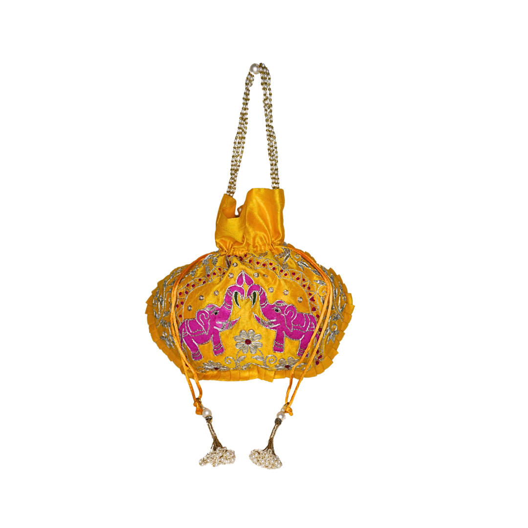 Yellow handbag with pink elephants and decorative elements on a white background